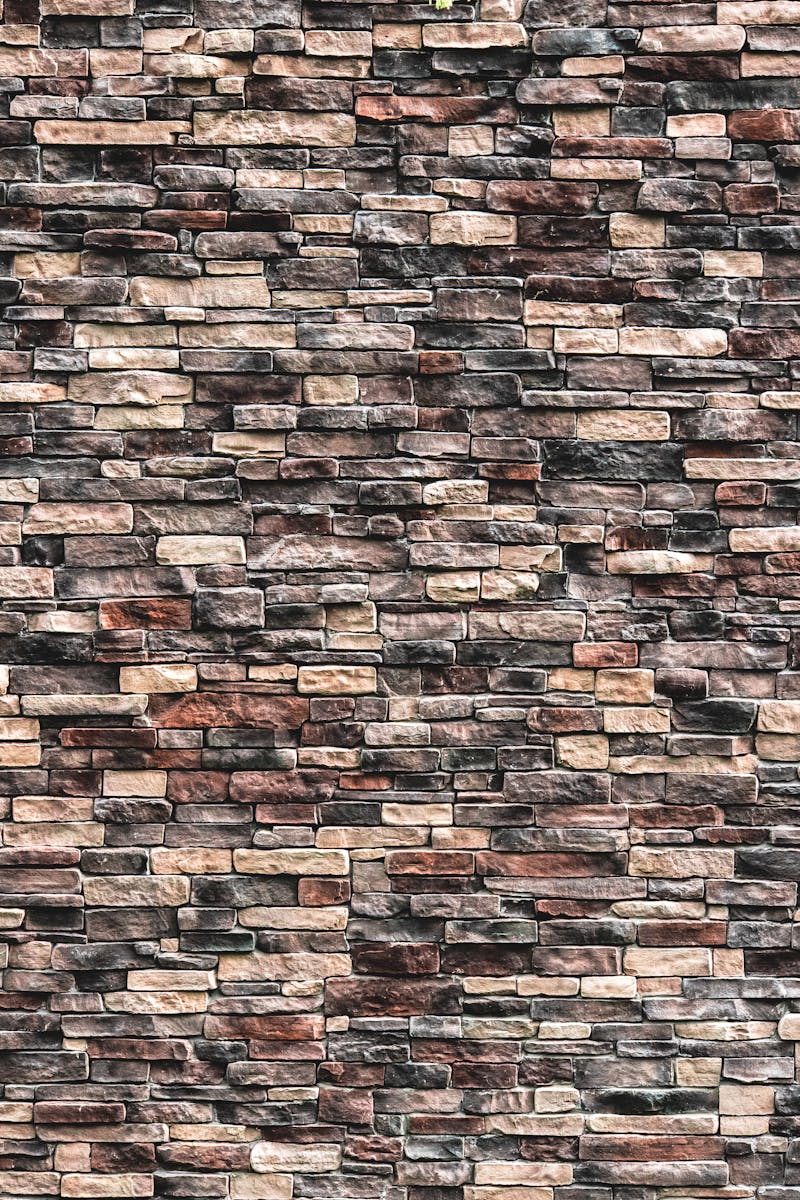A detailed close-up view of a natural stone brick wall texture for design purposes.