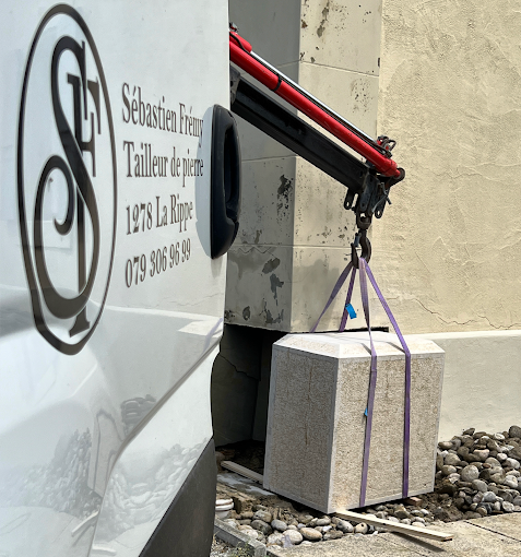 A sculptor skillfully uses a chisel to shape a marble statue indoors, showcasing artistry and craftsmanship.